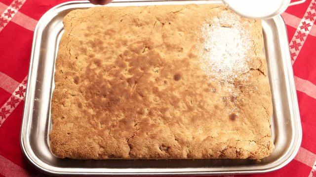 Powdered sugar  is strewed on the surface of the pie 