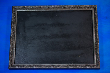Slate in the frame, blue background