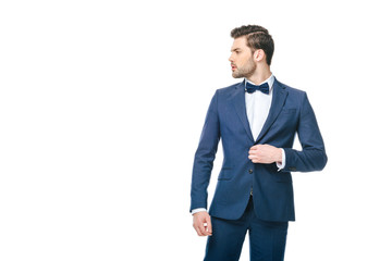portrait of young man in fashionable suit looking away isolated on white