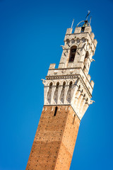 Obraz premium Close up of Torre del Mangia (Mangia tower) in Siena, Tuscany, Italy