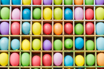 entertainment, party, amusement concept. there is a colorful background of popular attraction and contest with lots of balloons on the shelves in form of squares