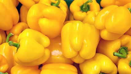 A bunch of beautiful fresh ripe yellow peppers.