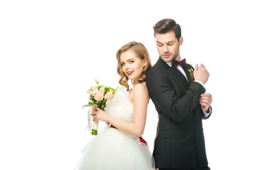 portrait of bride and groom standing back to back together isolated on white