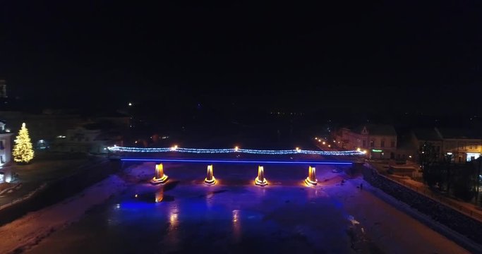 Aerial view: Fire Theater near the illuminated bridge on frozen river