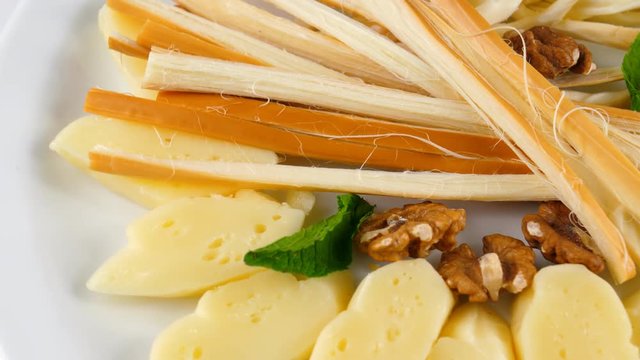Plate with various types of cheese, close-up, loop, 4K, ProRes codec, 422 HQ