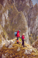 adventure, travel, tourism, hike and people concept - smiling couple walking with backpacks outdoors