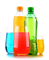 Glasses and bottles of assorted carbonated soft drinks
