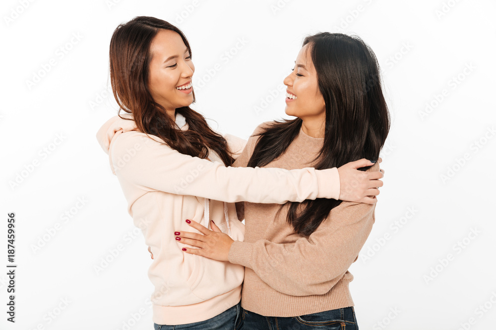 Poster two asian pretty ladies sisters hugging with each other.