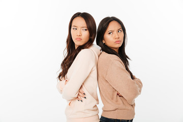 Asian angry ladies sisters standing isolated