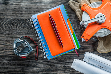 Construction drawings measuring tape protective gloves notepads 