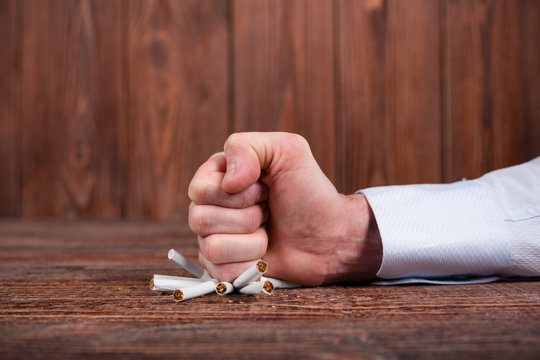 Man's hand crushing cigarettes. Quit smoking. Concept.