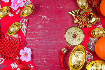 Chinese new year festival decorations, ang pow or red packet and gold ingots. Chinese characters...