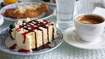 sweet cake and coffee at outdoor restaurant on a table