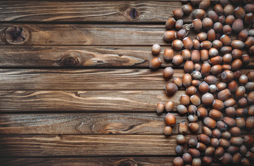Hazelnut on a wooden background. Useful autumn food. Snacks. Copy space.