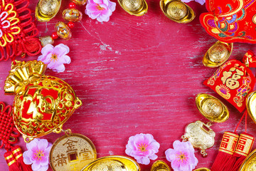 Chinese new year festival decorations, ang pow or red packet and gold ingots. Chinese characters means luck,wealth and prosperity.