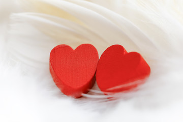 Red wooden heart with white background.