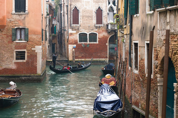 Fototapeta na wymiar Gondola ride in Venice canal , Italy