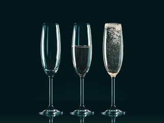 three glasses with different level of champagne on black