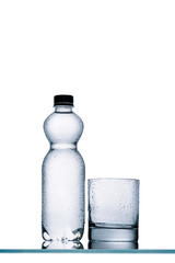 wet full plastic bottle of water and empty glass isolated on white