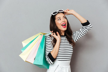 Portrait of a cheerful woman holding shopping bags