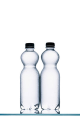 wet plastic bottles of water isolated on white