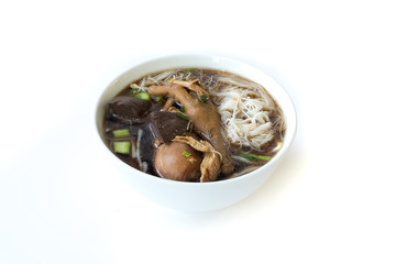 stewed chicken drumstick soup with noodle in bowl on white background (thai style)