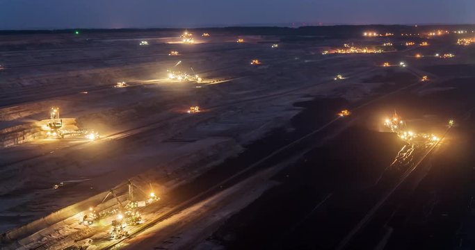 Group of coal diggers in opencast pit coal mine day to night time-lapse