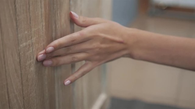Woman hand open drawer bathroom new furniture close up