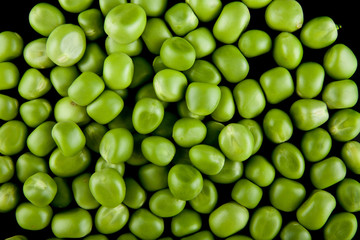 green peas on a black background