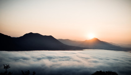 Obraz premium Early morning foggy sunrise on top of mountain soft focus.