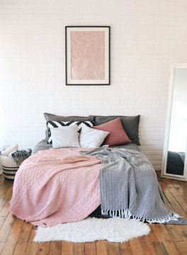  interior of bedroom using bed, mirror, pattern, textile on white brick wall background