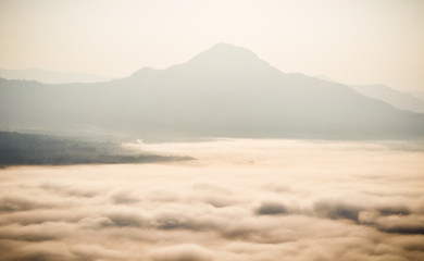 Early morning foggy sunrise on top of mountain soft focus.