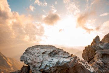 Sunset between rocks and clouds in the mountains. Mountain landscape