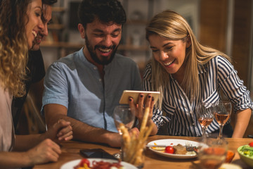 Friends looking at mobile phone
