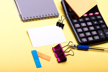 Stationery and calculator. Business card with empty space