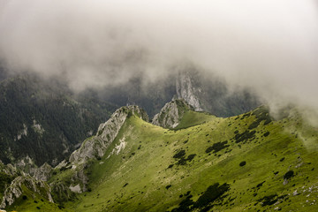 Beautiful landscape with peaks surrounded by clouds. Western Tatra Mountains. Poland.