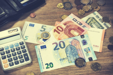 Euro banknotes and coins with bills to pay. Finances and budget