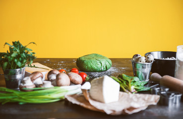 Ingredients for green ravioli in the form of heart from spinach with ricotta. prepared by the hostess for a festive dinner on St. Valentine's Day