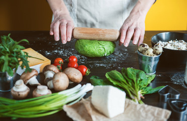 Chef cook step by step makes green ravioli in the shape of a heart for a festive dinner