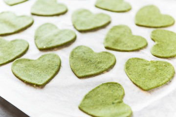 Chef cook step by step makes green ravioli in the shape of a heart for a festive dinner