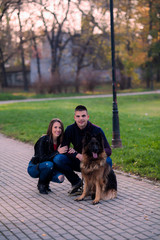 Portrait of affectionate couple with their dog in the park