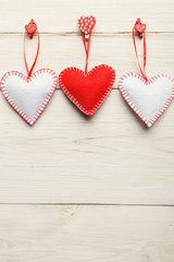 Valentine day background, handmade pillow hearts on wood, copy space