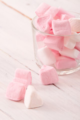 Marshmallows on wooden table.
