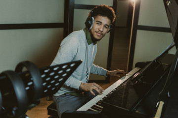 handsome smiling piano player performing song
