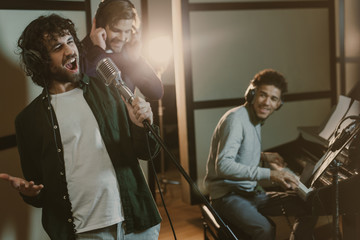 band of musicians performing song at studio together