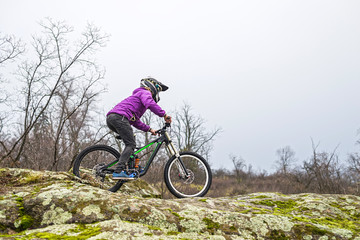Enduro Cyclist Riding the Mountain Bike on the Rocky Trail, copy of free space.