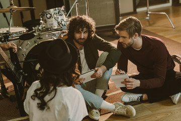 young band writing music together while sitting on floor