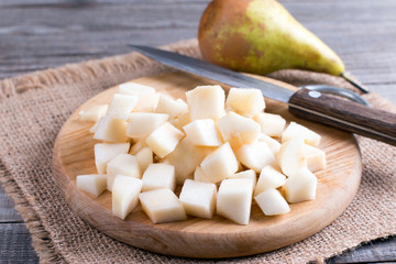 Cubes of pears on a cutting board on a table