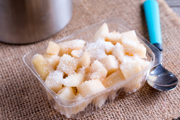 Cubes of pears in a container with sugar. Harvest for the winter