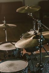 Close-up shot of drum set under spotlight on stage
